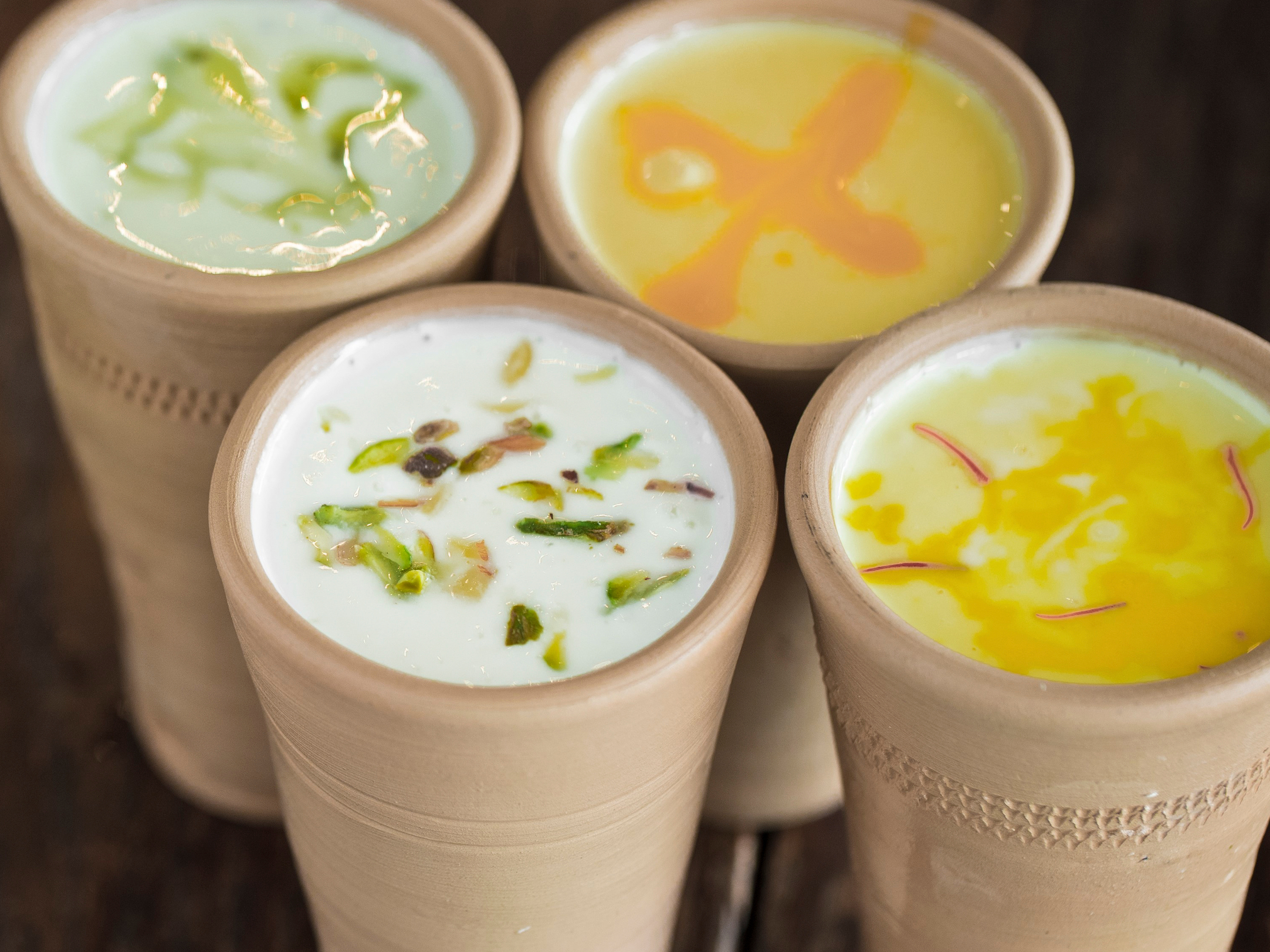 Shikanjvi and lassi in brown cups close-up photo communal living