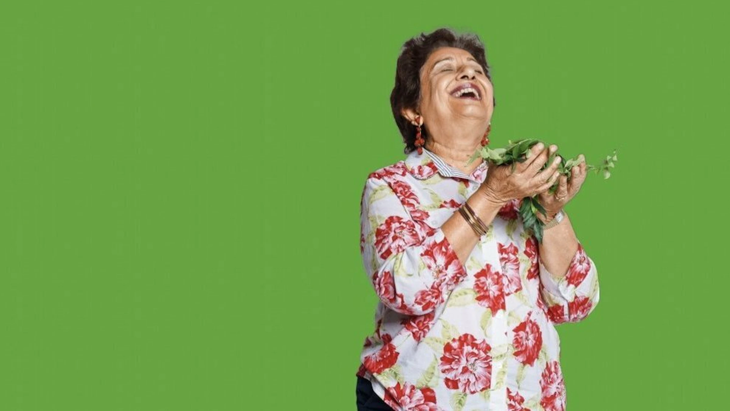 Woman Holding Plants & Laughing Communal Gardening